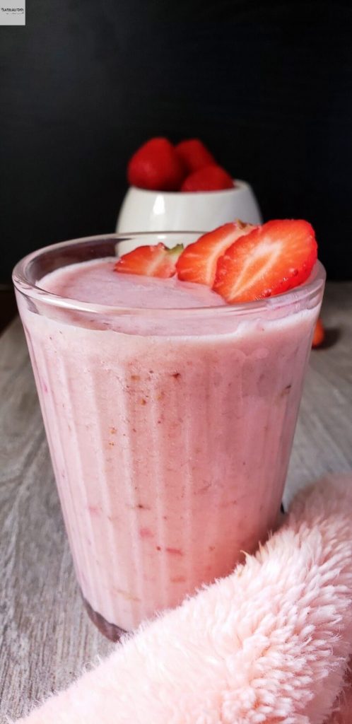 Glass of strawberry banana smoothie.