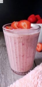 Glass of strawberry banana smoothie.