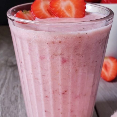 Glass of strawberry banana smoothie.