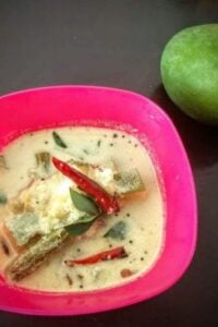 A bowl of raw mango drumstick curry.