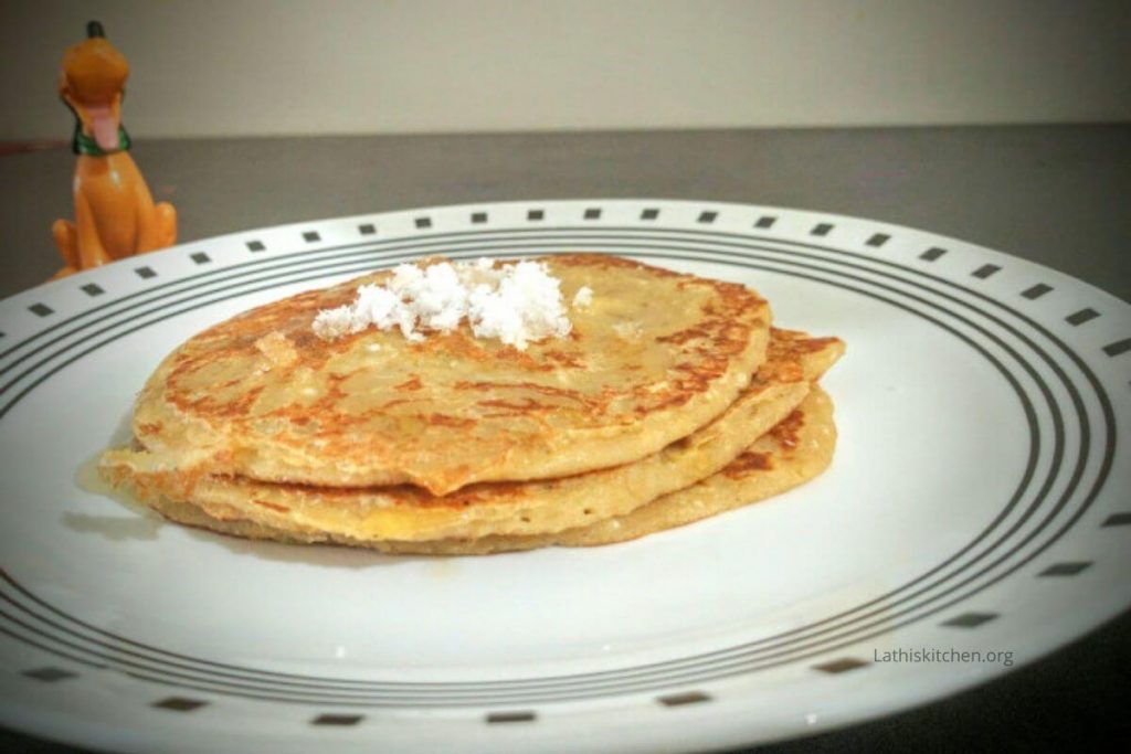 Delicious Whole Wheat Coconut Pancake with grated coconut on top.