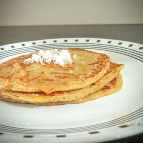 Delicious Whole Wheat Coconut Pancake with grated coconut on top.