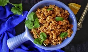 Bowl of Cauliflower Stir fry with lemon wedge on side.
