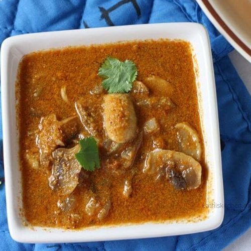 Bowl of Mushroom curry with chopped cilantro on it.
