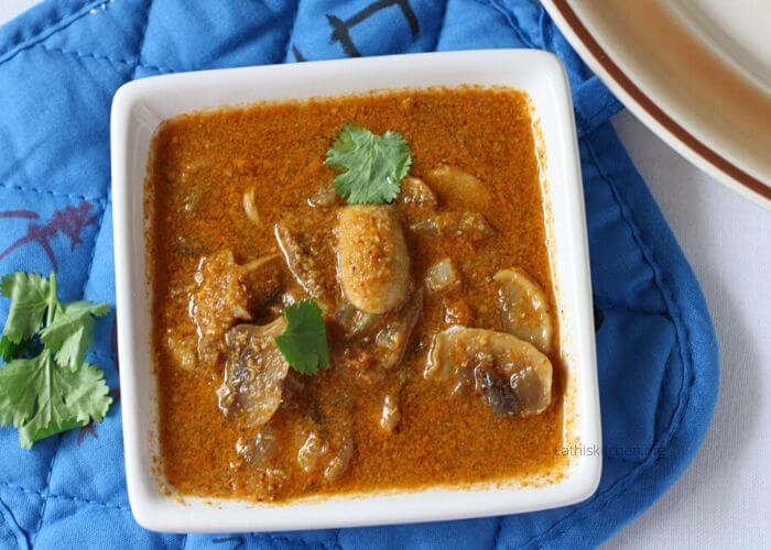 Bowl of Mushroom curry with chopped cilantro on it.