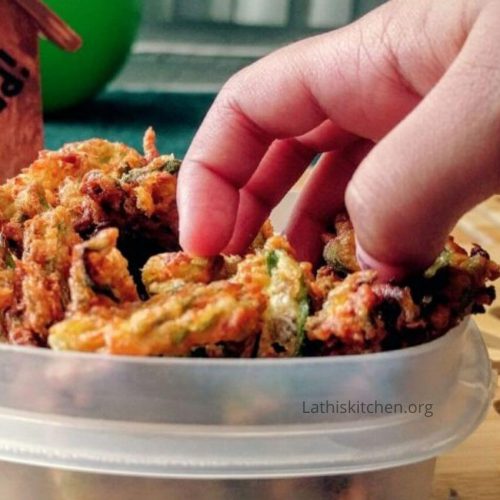 A hand picking crispy okra fry.