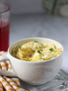 Microwave scrambled eggs in a mug with chopped cilantro.