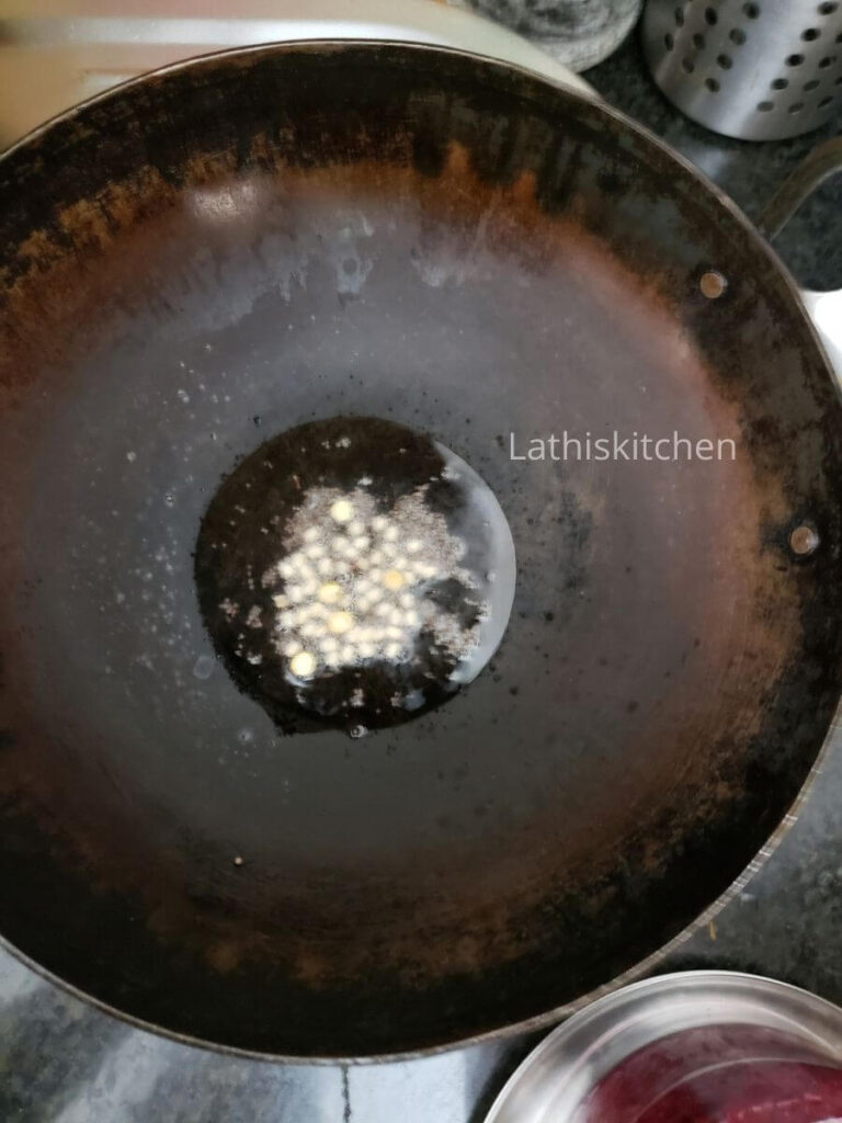 Pan with spluttering mustard seeds and lentils.
