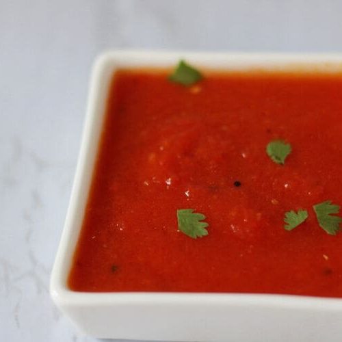 A bowl of tomato chutney.