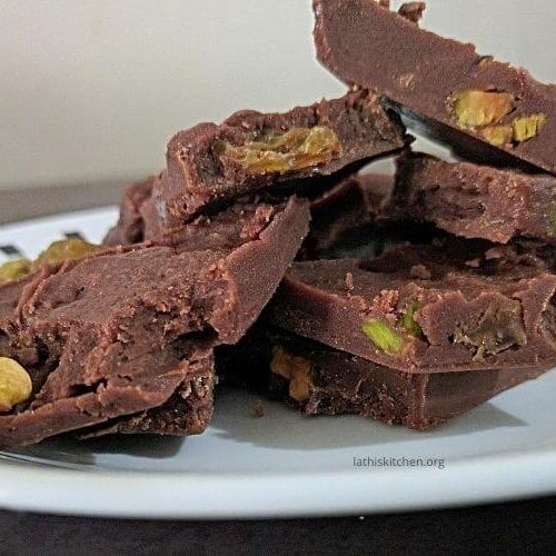 A plate of homemade chocolate with dry fruits.