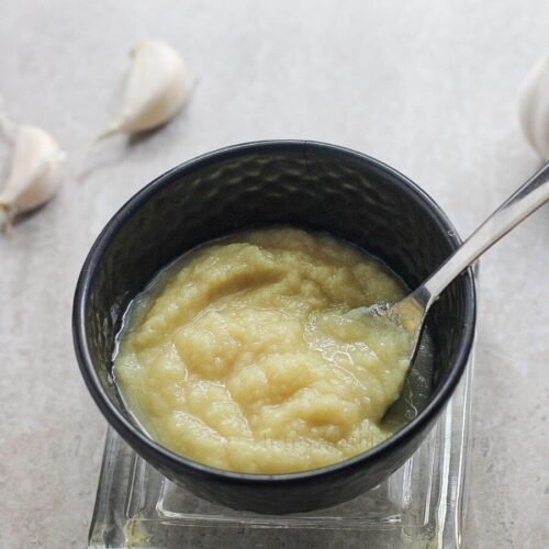 Ginger garlic paste in a bowl with a spoon.