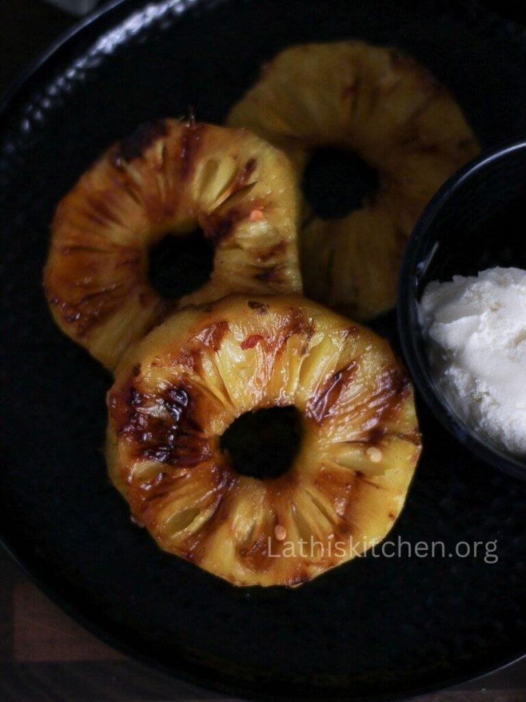 Grilled pineapple slices on a plate.