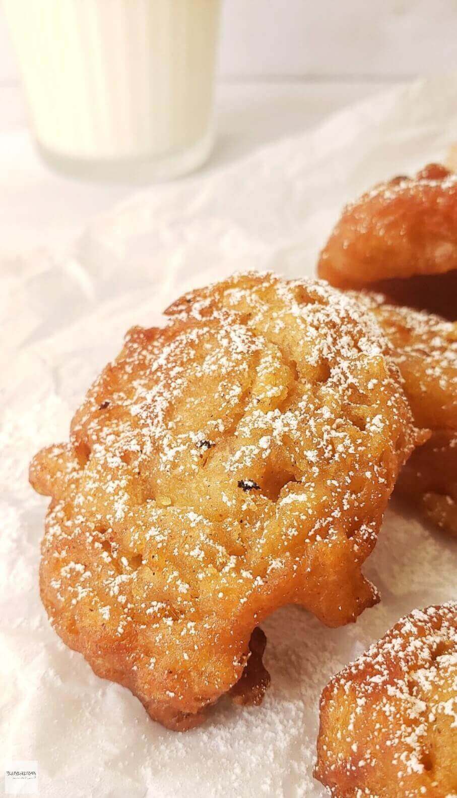 Powdered sugar dusted apple fritters.
