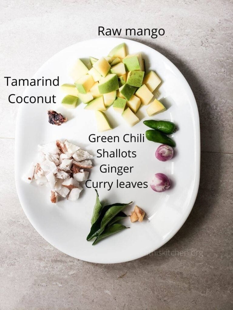 A plate with ingredients to make raw mango chutney with coconut.