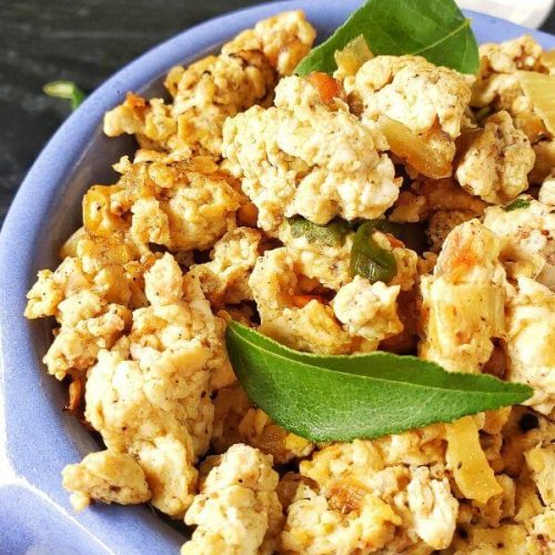 Bowl of Egg Bhurji with curry leaves.