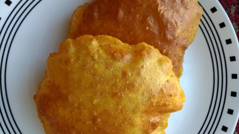 Two piece of aloo poori in a plate.