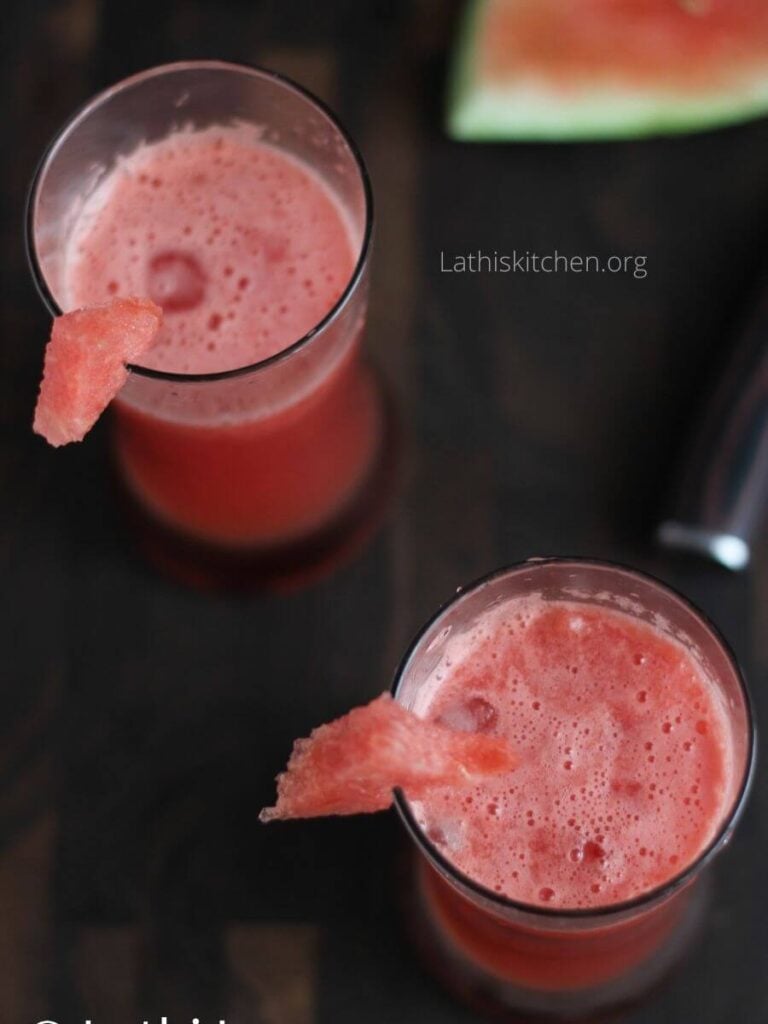 Top view of two glasses filled with drink and watermelon pieces on glass.