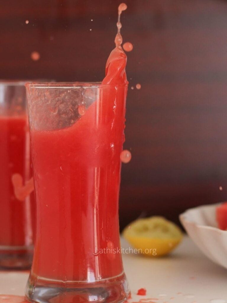 Juice splashing in a glass.