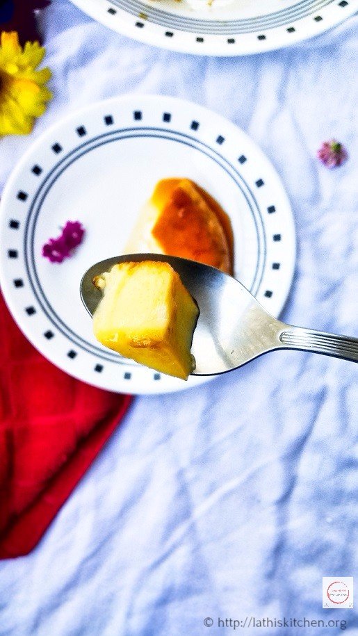 A spoon of caramel custard