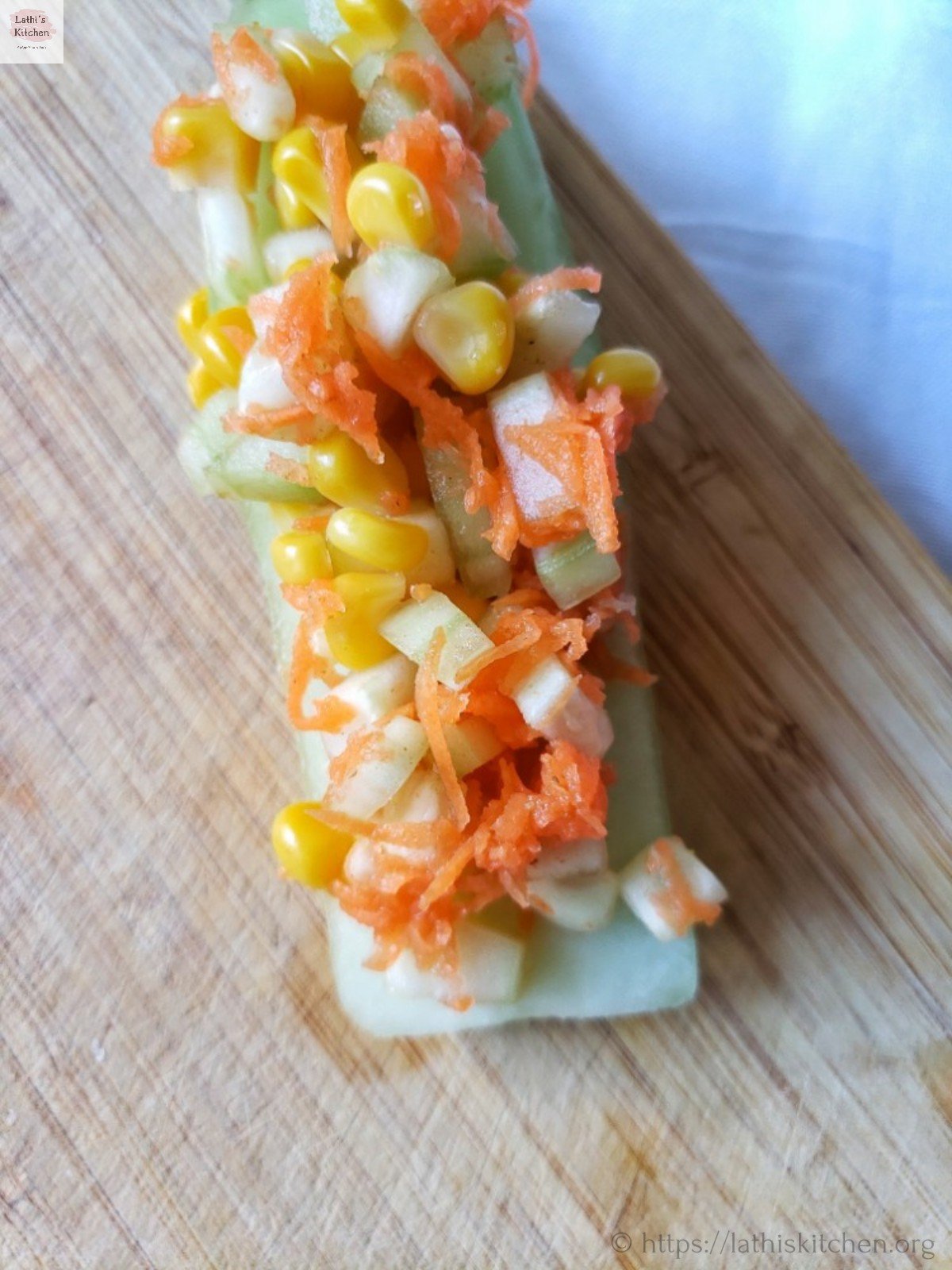 Corn, cucumber and carrot salad placed on a slice of cucumber.
