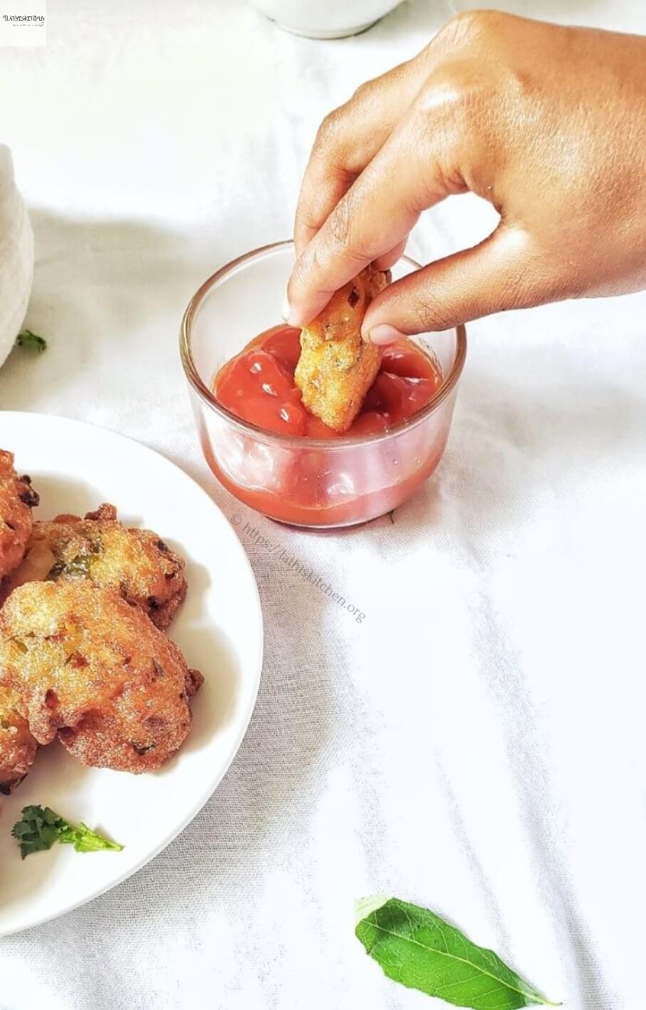 Semolina fritters dipped in ketchup.