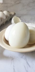 Peeled hard boiled egg in a bowl.
