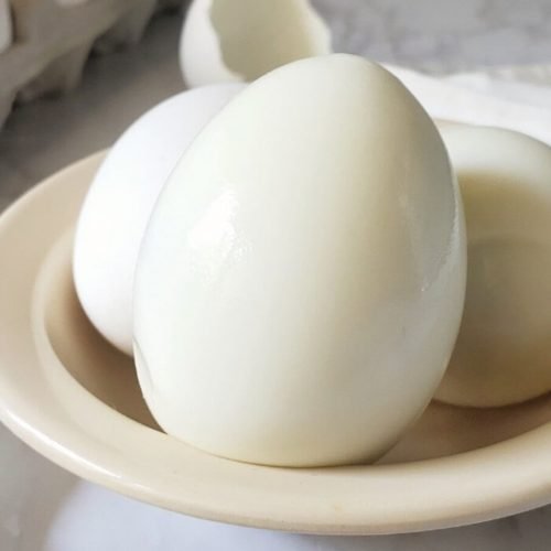 Peeled hard boiled egg in a bowl.
