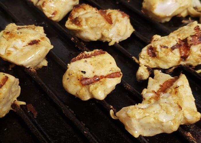 Grilled chicken cubes in grill pan.