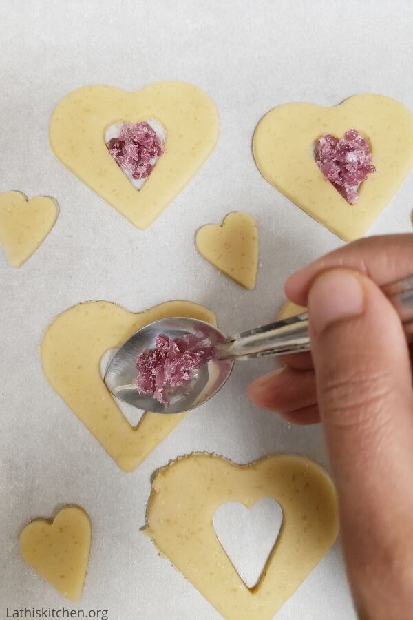 Heart shaped cookies filled with crushed candies.