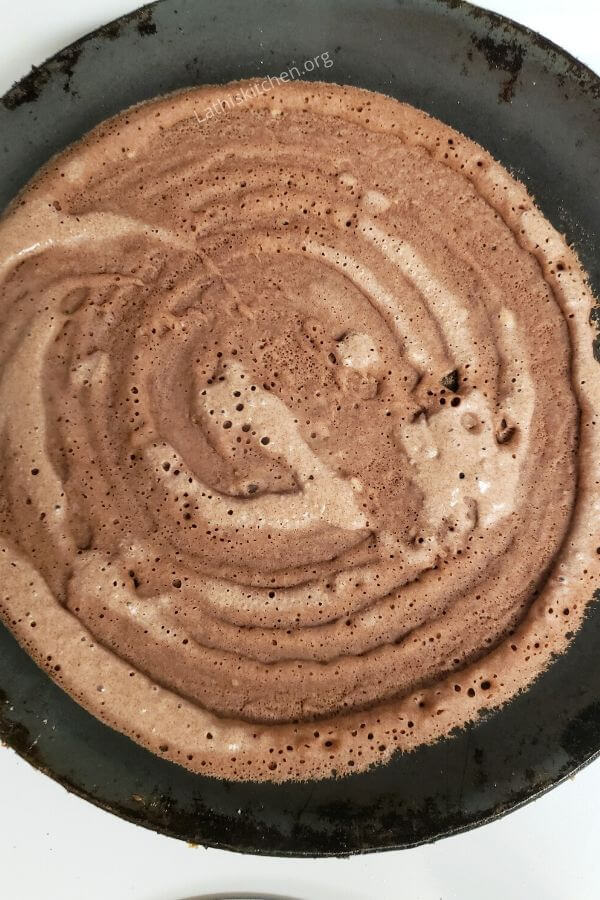 Dosa in the cast iron pan.