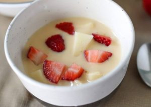 Close up of bowl of fruit custard.