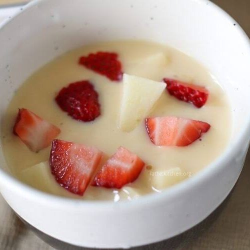 Close up of bowl of fruit custard.