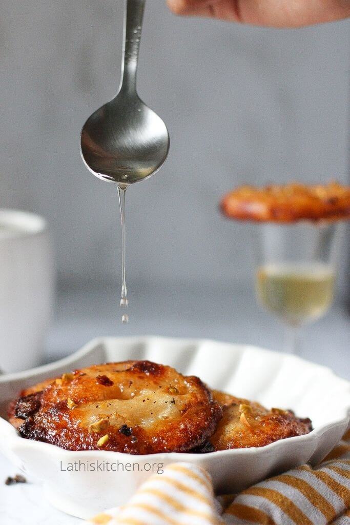 Sugar syrup drizzled over apple jalebi.