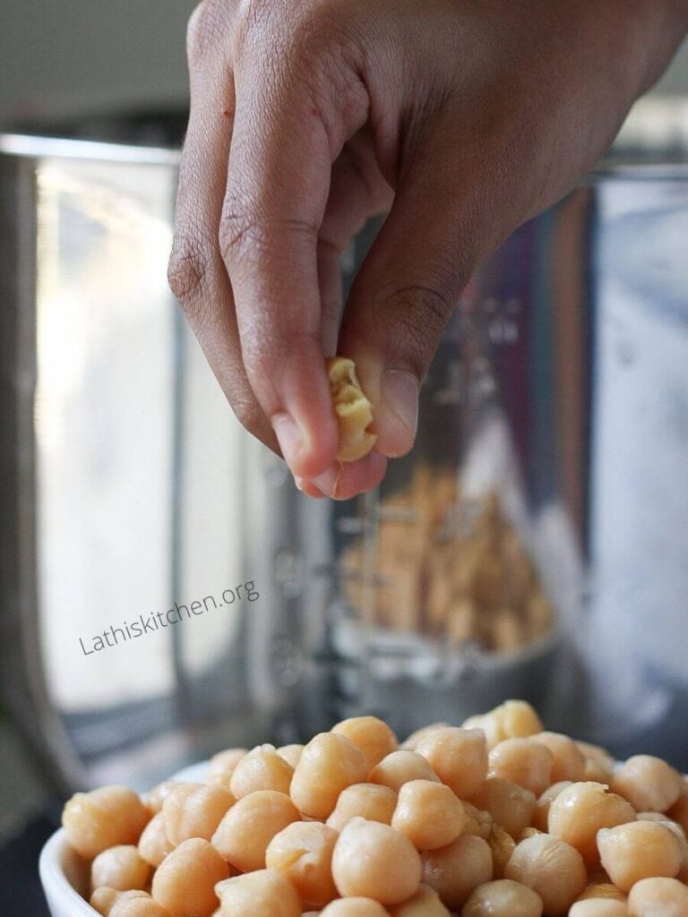 Chickpeas mushed in a hand. 