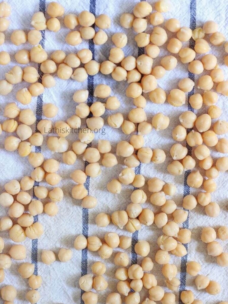 Cooked chickpeas drying in kitchen towel.