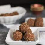 jackfruit seed ladoo on a plate with plates on background.