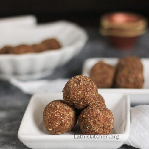 jackfruit seed ladoo on a plate with plates on background.