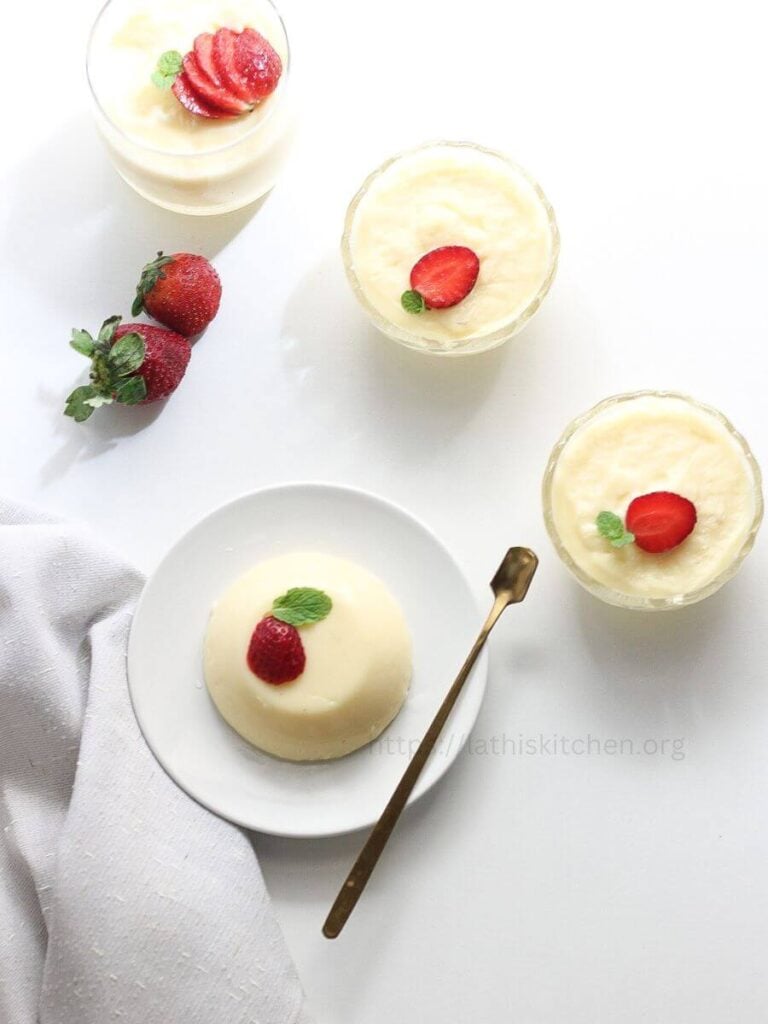 4 ingredients milk pudding on a plate with strawberry and mint leaf on top.