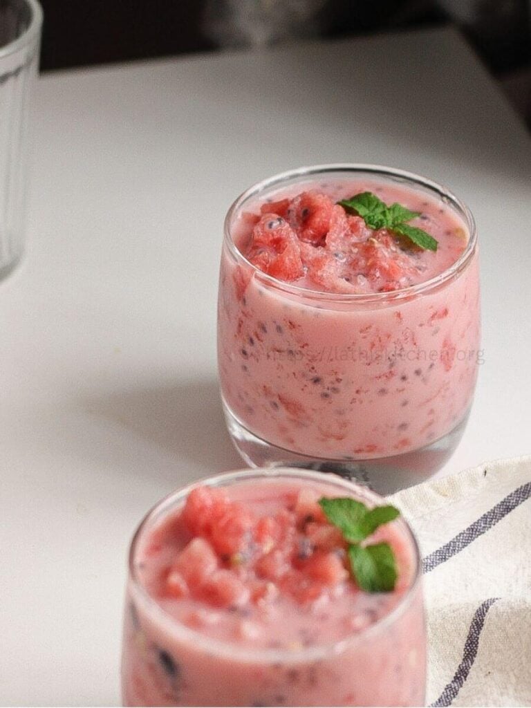 A glass of mohabbat ka sharbat with mint leaf on it.