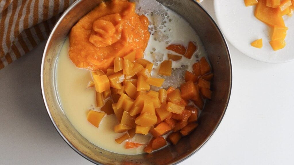 A bowl with all ingredients for mango sago.