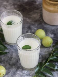Two glasses of Indian buttermilk with gooseberry.