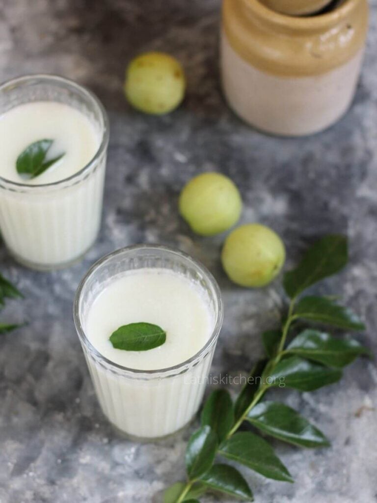 Two glasses of Indian spiced buttermilk with gooseberry.